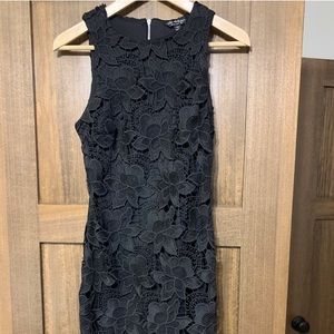 Black lace sleeveless dress with fringe hem detail
